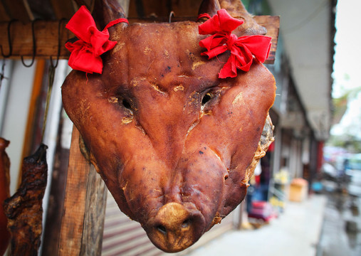        镇前小店悬挂着的硕大猪头